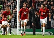 Manchester United's Jonny Evans (C) celebrates with Michael Carrick (R) after scoring